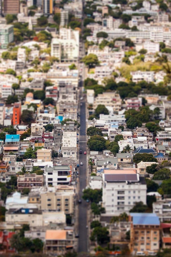 Aerial view of Port Louis, capital of Mauritius, with its narrow streets and basic dwellings. A few cars drive along the main avenue.
