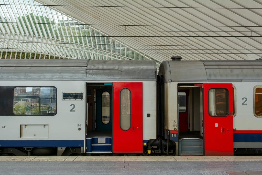 Photo of train carriages stopped at a station platform in Belgium.