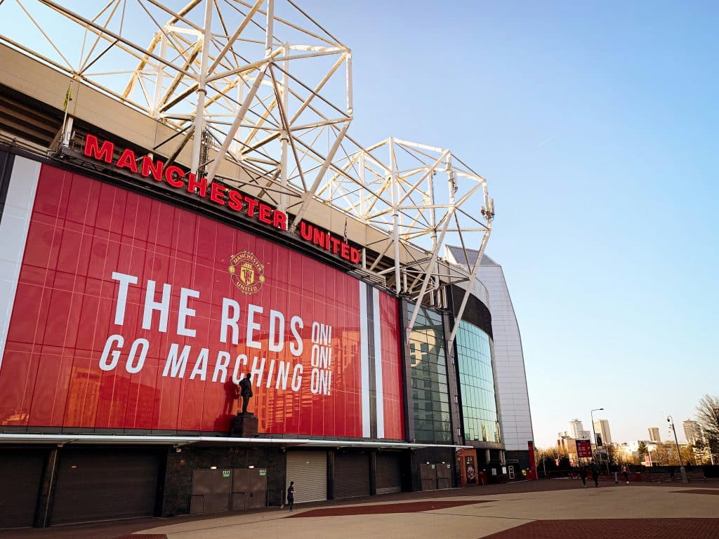 Front of Manchester United stadium in Manchester, England. The dominant color is red, the color of the football club's team.