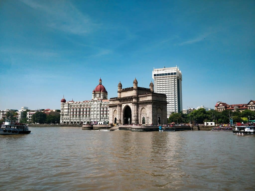 View of the Gateway of India from the sea on a sunny day.
